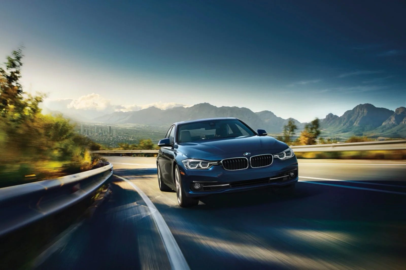 BMW 3 Series driving with mountainous backgrounds