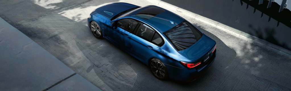 2024 BMW 5 Series blue sedan on the street